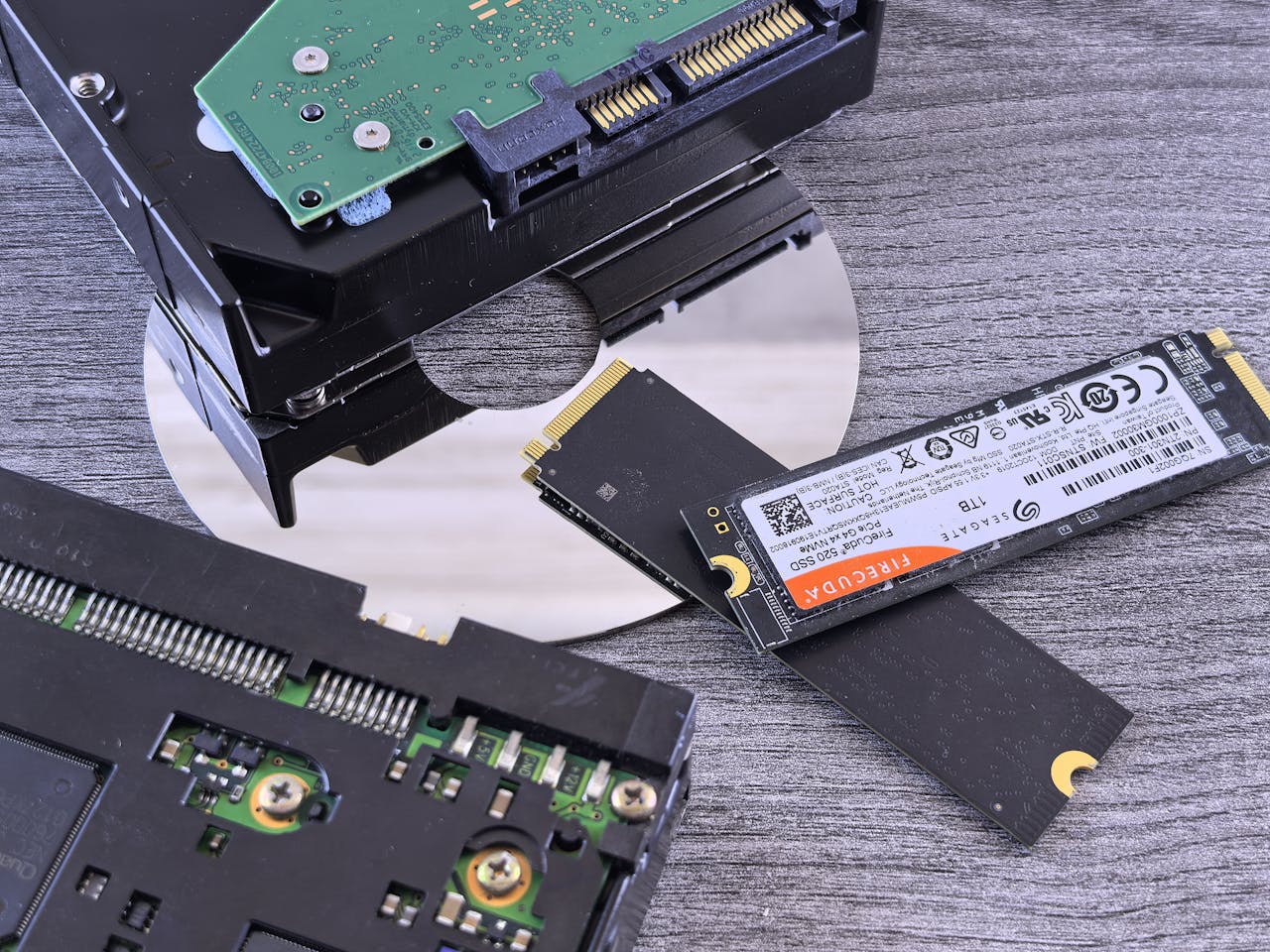 Home Contrasting data storage technologies: NVMe SSD, HDD, and CD.