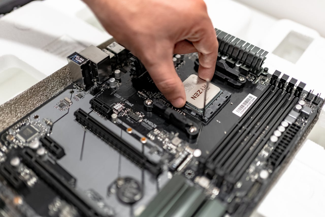 Home Person's hand installing a CPU on a motherboard, showcasing PC maintenance and repair.